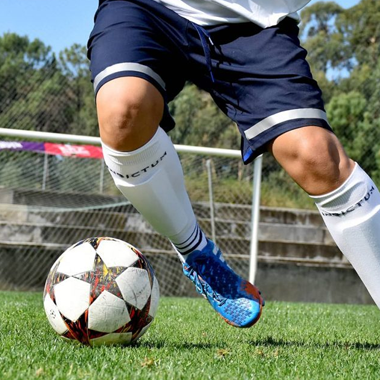 These socks are designed for football/soccer players, offering support and protection during intense gameplay. They are long and elastic, covering the shin guards for added functionality.